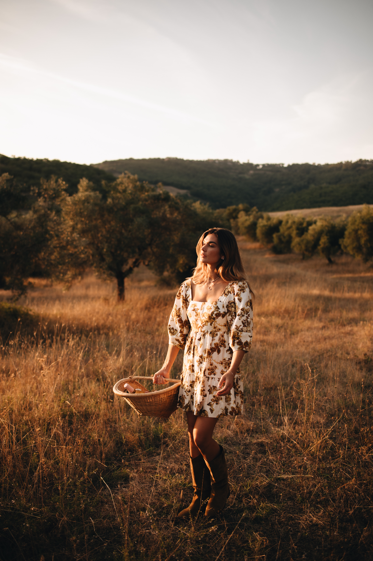 Shayna with harvest basket in the olive grove
